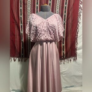 Vintage pink women’s dress with small waist and flares at the bottom